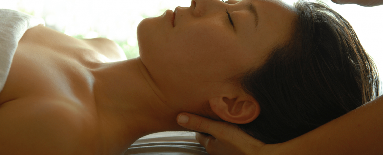 Woman at day spa receiving massage